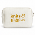 White waffle pouch with metallic yellow gold “Knits & Giggles” embroidery.