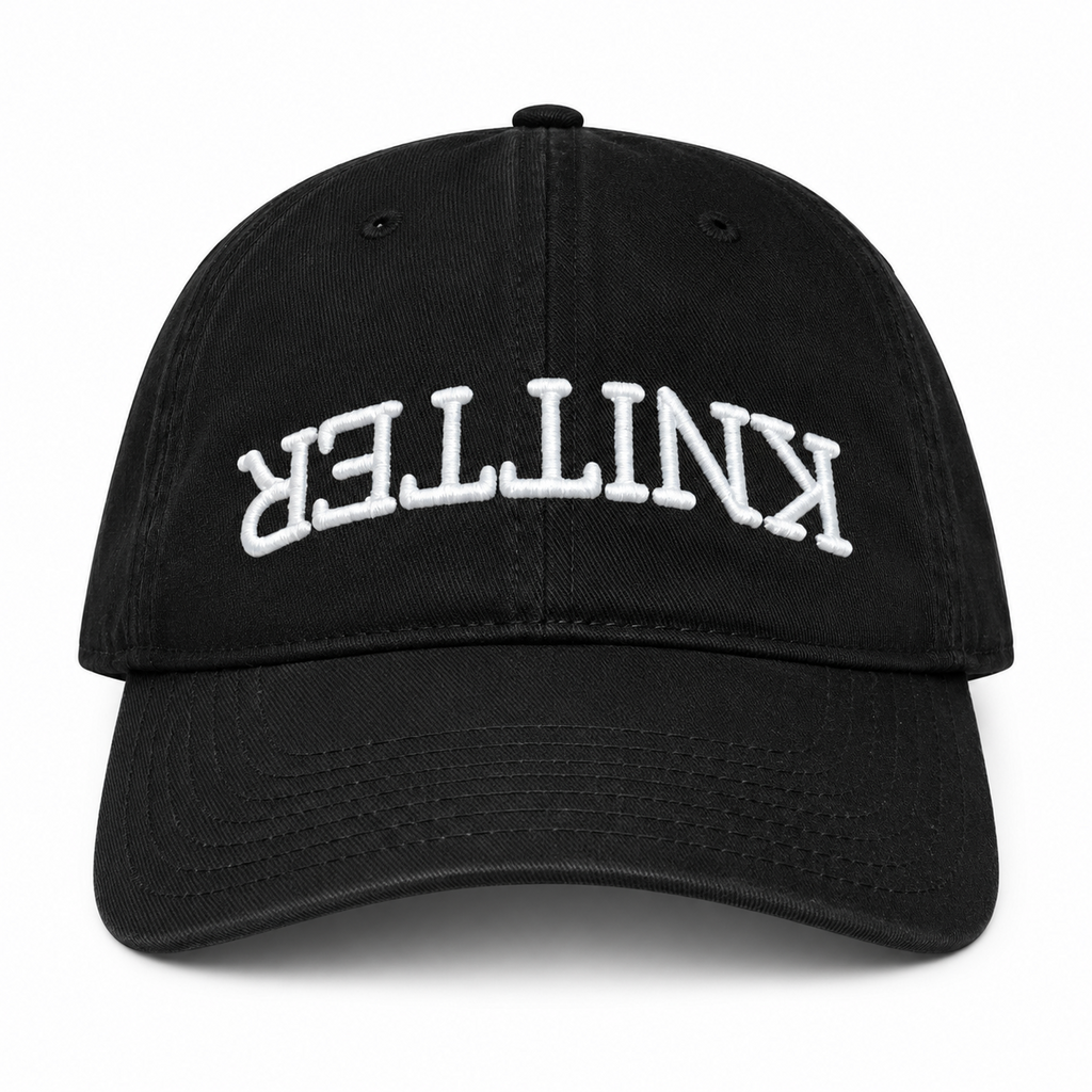 Black hat with white puff embroidered upside-down Knitter lettering