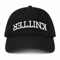 Black hat with white puff embroidered upside-down Knitter lettering
