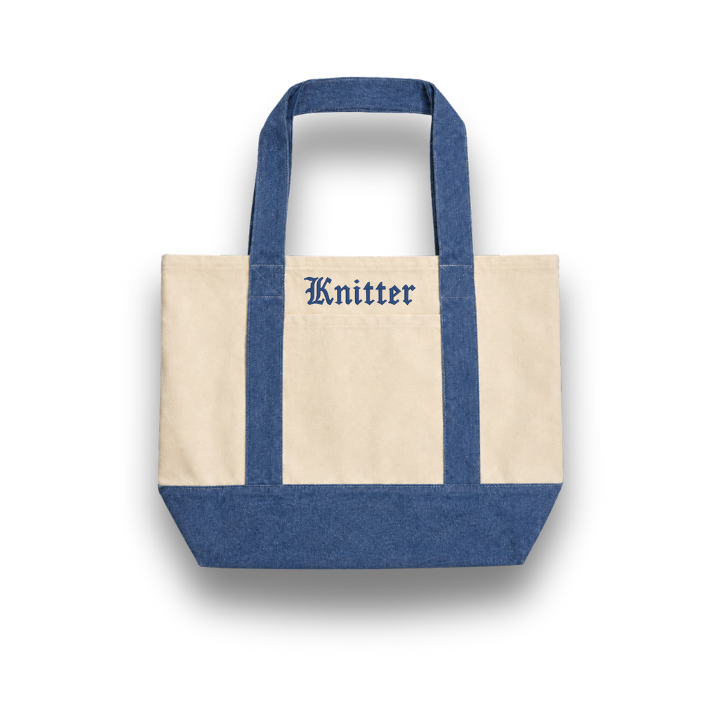 Tote bag with blue handles and bottom, featuring the brand 'Knitter'.