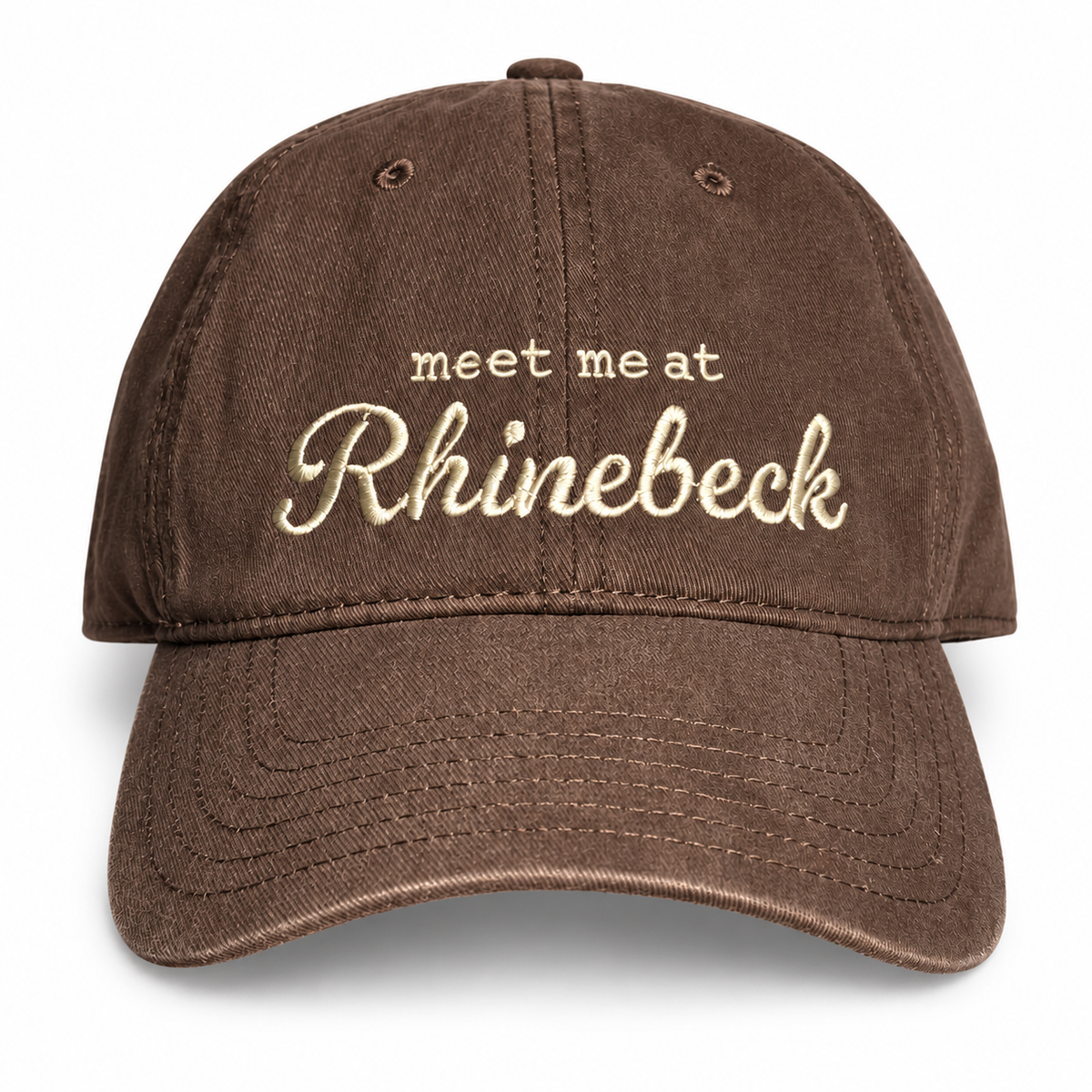 A brown washed cotton baseball cap with cream-colored embroidered text reading 'meet meat Rhinebeck' on the front, shown against a plain white background.