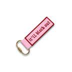 Pink keychain with gold carabiner and text on a white background