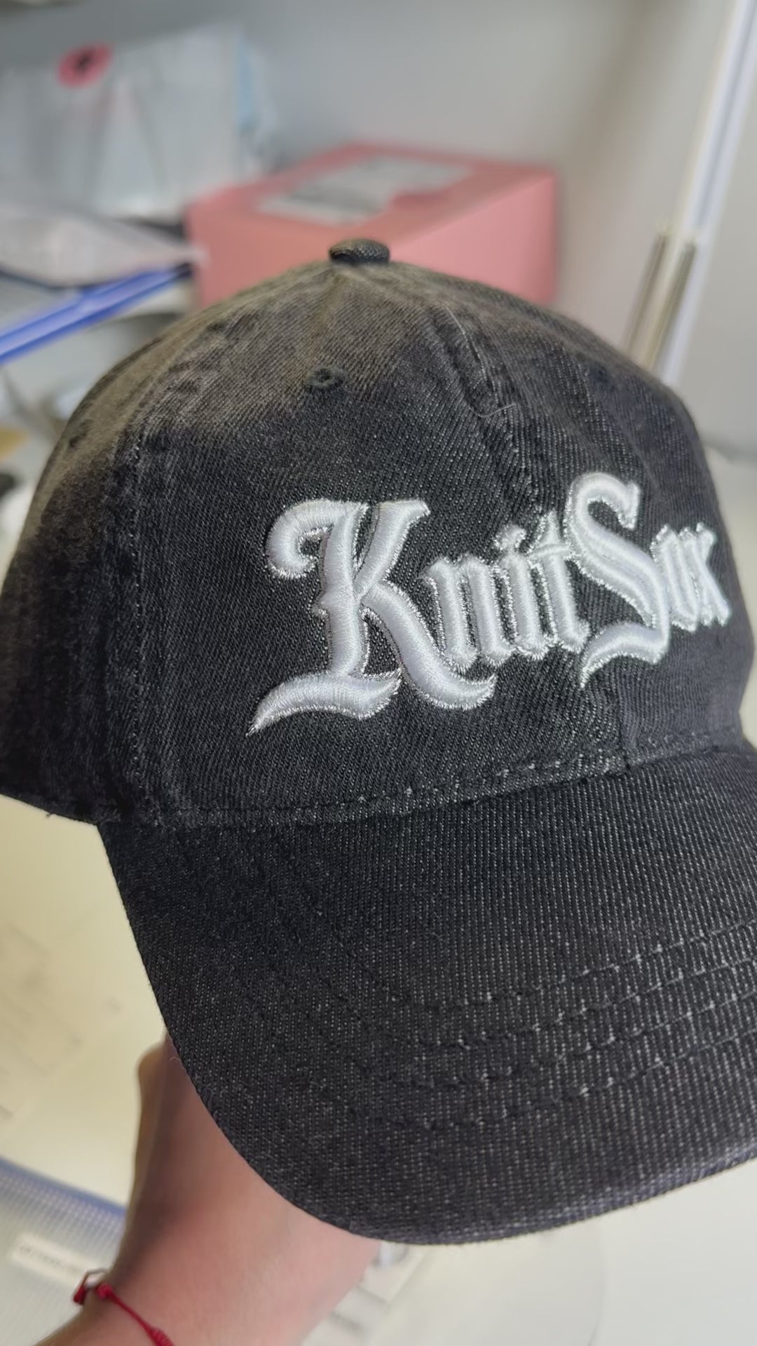 Black denim hat with Knit Sox white puff embroidery and metallic silver embroidered detail