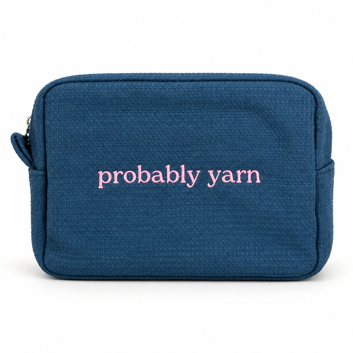 A navy blue textured canvas pouch with the words 'probably yarn' embroidered in pink lowercase letters on the front, shown against a plain white background.