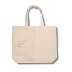 Beige tote bag with 'resting stitch face' text on a white background