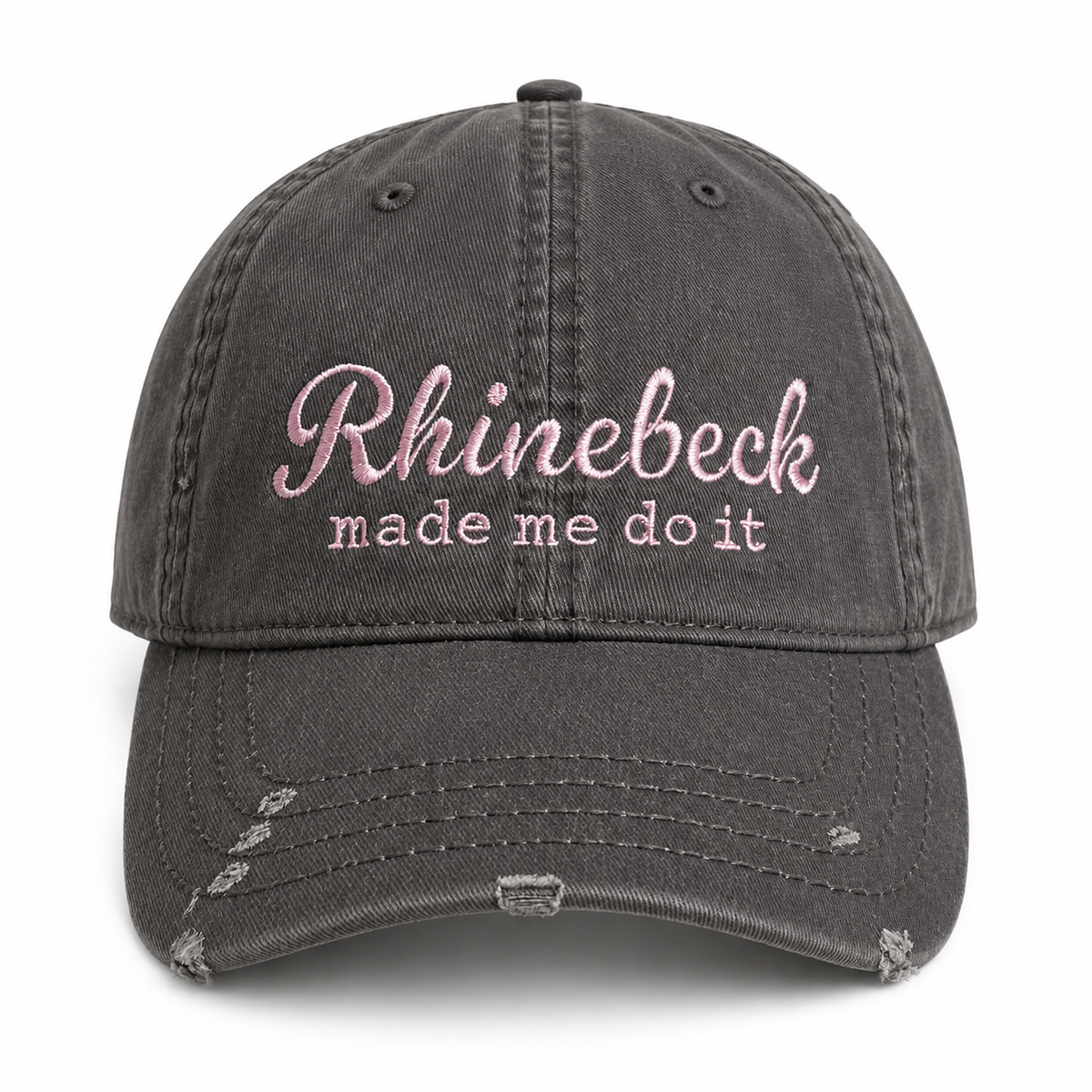 A dark gray distressed baseball cap with pink embroidered text reading 'Rhinebeck made me do it' on the front, shown against a plain white background.
