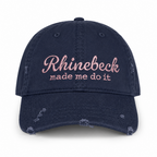 Distressed navy dad hat with pale pink “Rhinebeck Made Me Do It” embroidered lettering.