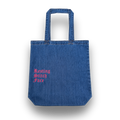 Blue denim tote bag with 'Resting Stitch Face' text in pink on a white background
