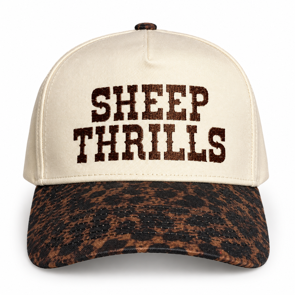 Cream structured Sheep Thrills hat with chocolate brown embroidery and brown-and-black leopard print brim.