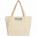 A natural canvas tote bag with dark blue text reading 'spiritually on gauge' on the front pocket, shown against a plain white background.