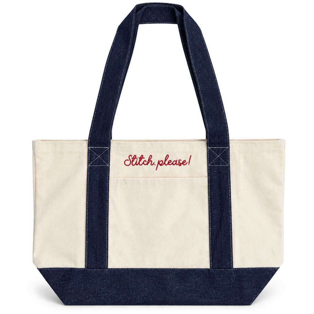 An off-white canvas tote bag with dark navy blue denim-style handles, bottom panel, and side straps, featuring the phrase 'Stitch, please!' embroidered in red script on the front pocket, set against a plain white background.