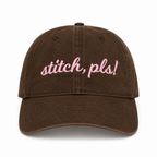 Dark brown dad hat with pale pink 3D puff embroidery reading Stitch, Pls!