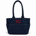 A dark navy blue fabric tote bag with two top handles, multiple front pockets, and 'Stitch Witch' embroidered in red Gothic-style lettering on the front, shown on a plain white background.