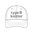 White hat mockup with grey Type B Knitter embroidery