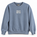 A dusty blue crewneck sweatshirt with 'VARSITY KNITTER' printed in white block letters on the chest, displayed against a clean white background.