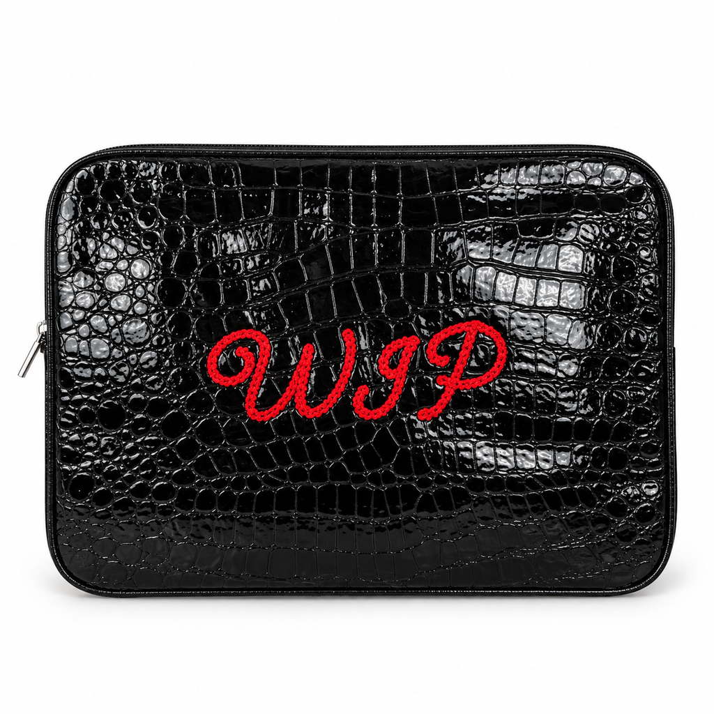 A black crocodile-embossed zippered pouch with red embroidered cursive initials 'WIP' on the front, shown against a plain white background.
