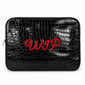 A black crocodile-embossed zippered pouch with red embroidered cursive initials 'WIP' on the front, shown against a plain white background.