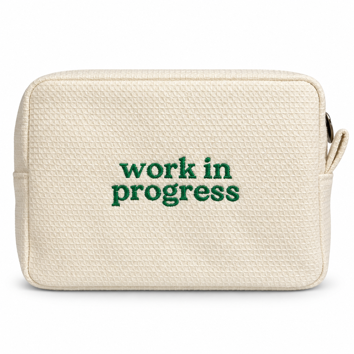 Butter yellow waffle zip pouch with green “Work in Progress” embroidery.