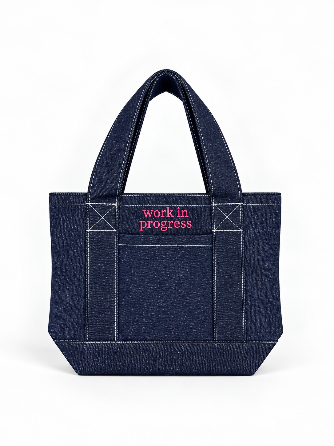 Dark denim mini tote with bright pink “Work in Progress” embroidery.