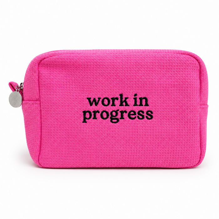 Hot pink waffle project pouch with black Work in Progress embroidery