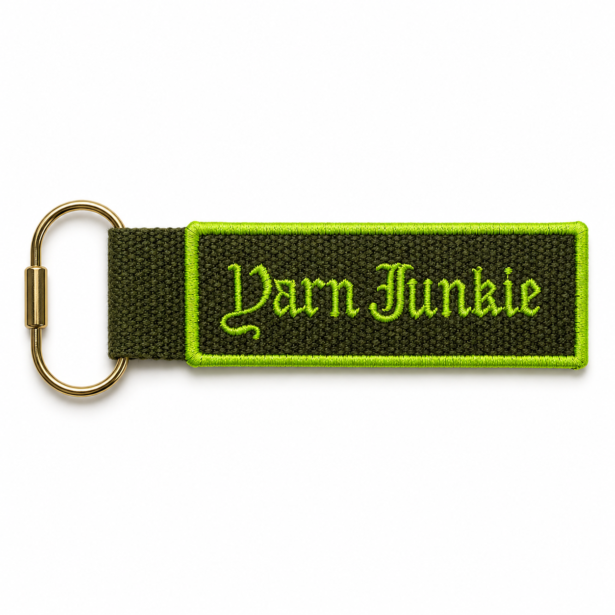 Olive green bag charm with neon green Yarn Junkie embroidery and gold-tone key ring hardware